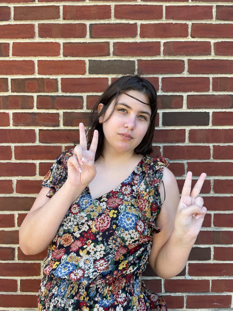 photo of Jessi Walker in a dress throwing peace signs