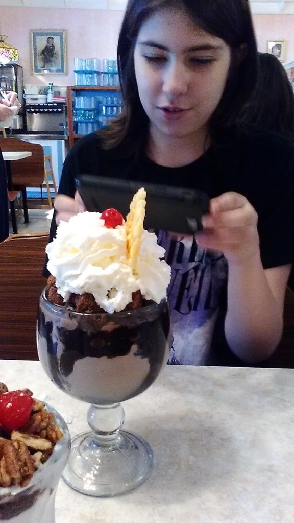 Teenaged Jessi Walker with huge ice cream with a cherry, whipped cream, and a waffle slice at Wildwood NJ's restaurant Duffers
